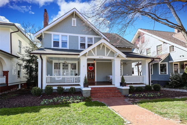 view of front facade with a front yard and a porch