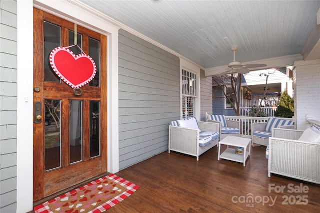 wooden deck with ceiling fan and a porch