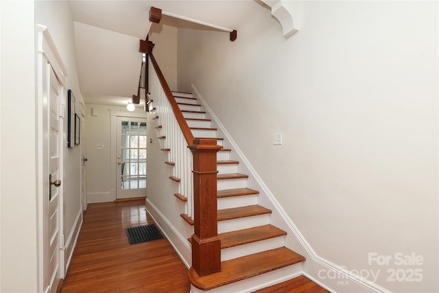 stairway featuring wood-type flooring