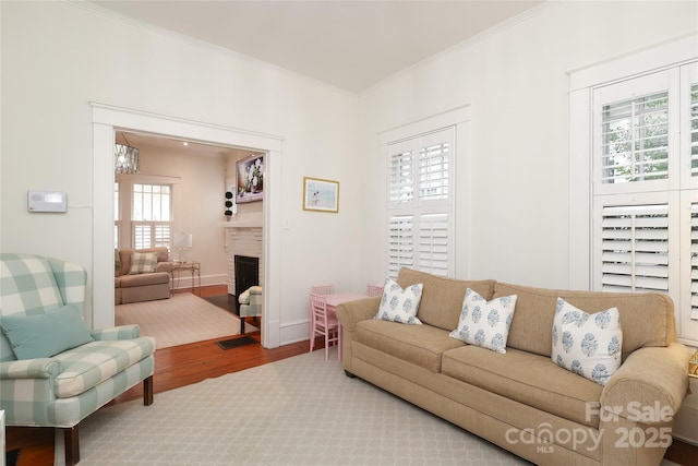 living room with crown molding and hardwood / wood-style floors