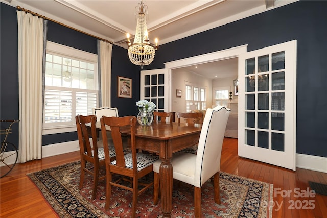 dining area featuring hardwood / wood-style flooring and a chandelier