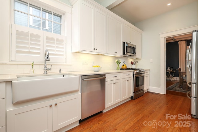 kitchen featuring white cabinetry, appliances with stainless steel finishes, and sink