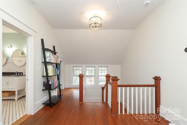 hall featuring lofted ceiling, sink, and dark hardwood / wood-style floors