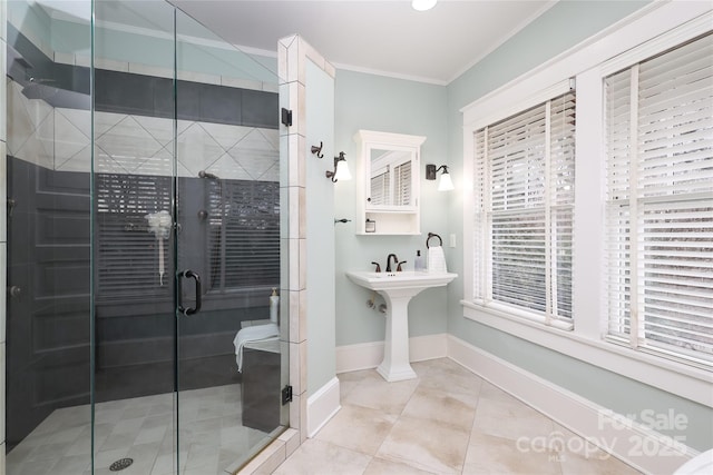 bathroom featuring crown molding, tile patterned floors, and a shower with shower door