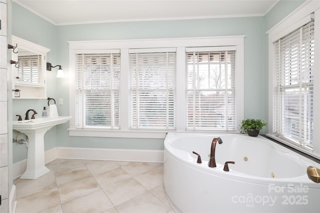 bathroom featuring crown molding, tile patterned flooring, a bathtub, and sink