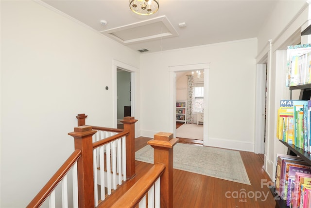 hall with hardwood / wood-style flooring and ornamental molding