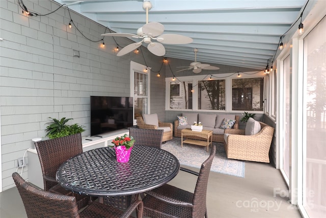 sunroom with vaulted ceiling with beams and ceiling fan