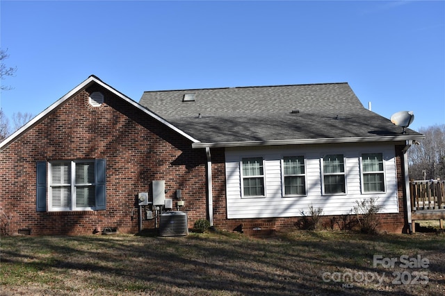 view of property exterior featuring central AC and a lawn