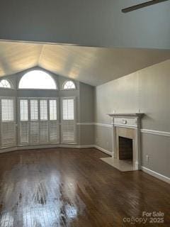 unfurnished living room featuring lofted ceiling and dark hardwood / wood-style floors