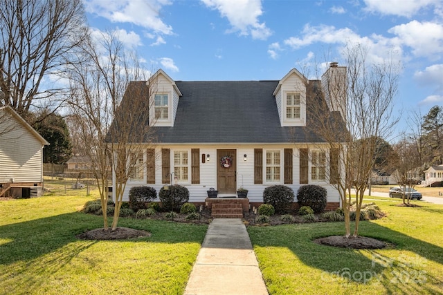 cape cod home with a chimney, a front yard, and central air condition unit