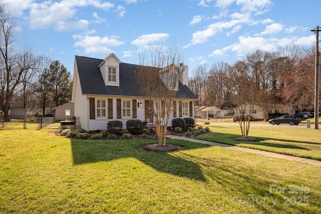 cape cod home with fence, a chimney, and a front lawn