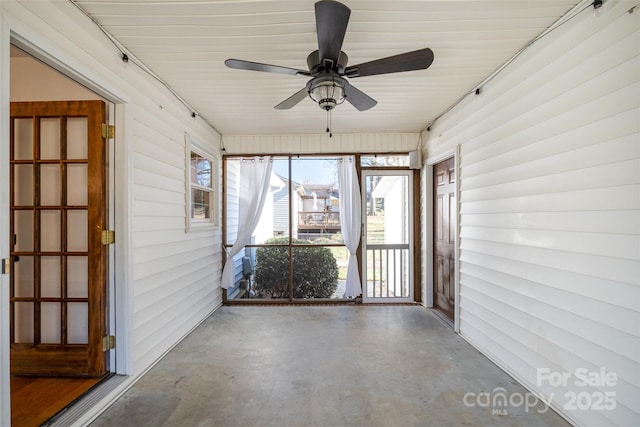 unfurnished sunroom with a ceiling fan