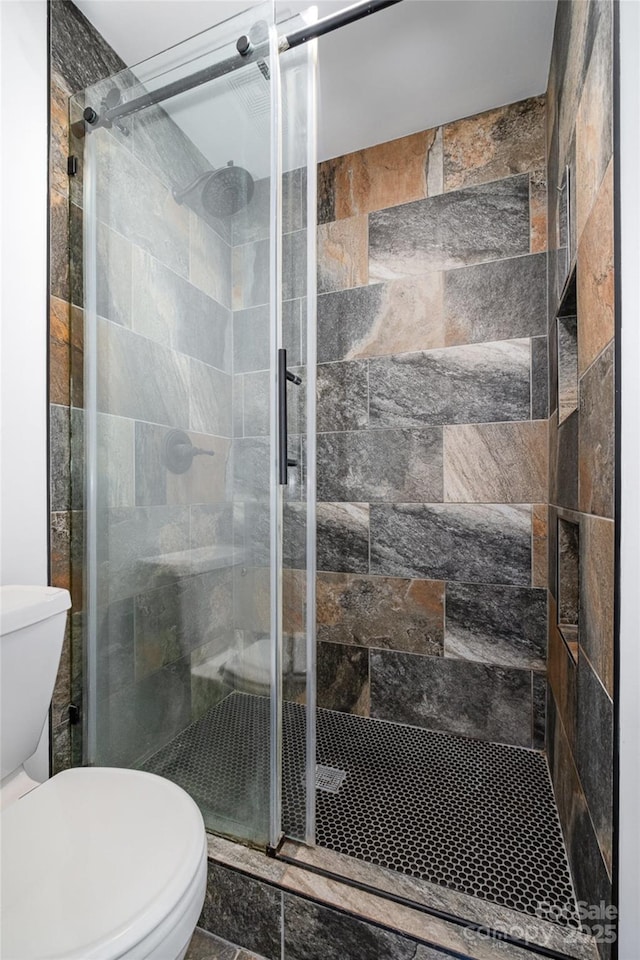 full bath with a shower stall and toilet