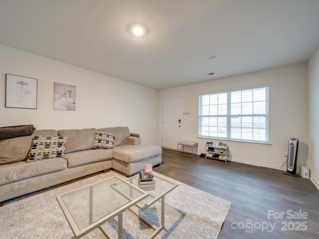 living room featuring dark wood-type flooring