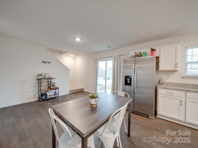 dining area with dark hardwood / wood-style flooring and a wealth of natural light