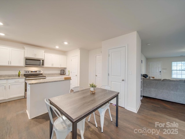 dining area featuring dark hardwood / wood-style flooring