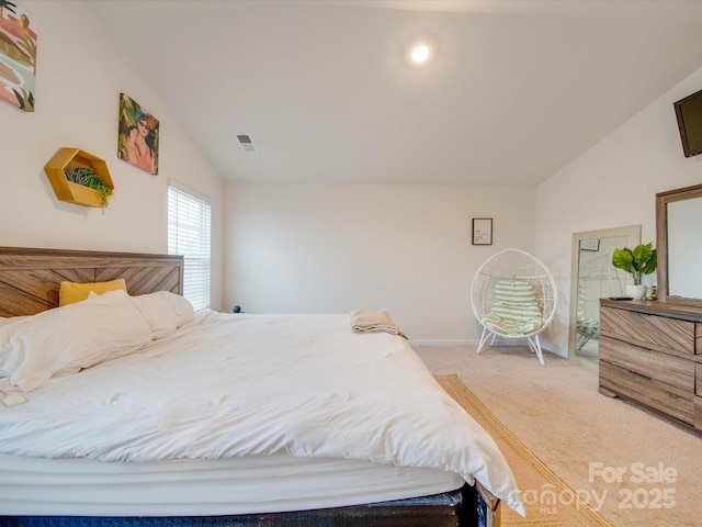 carpeted bedroom with vaulted ceiling