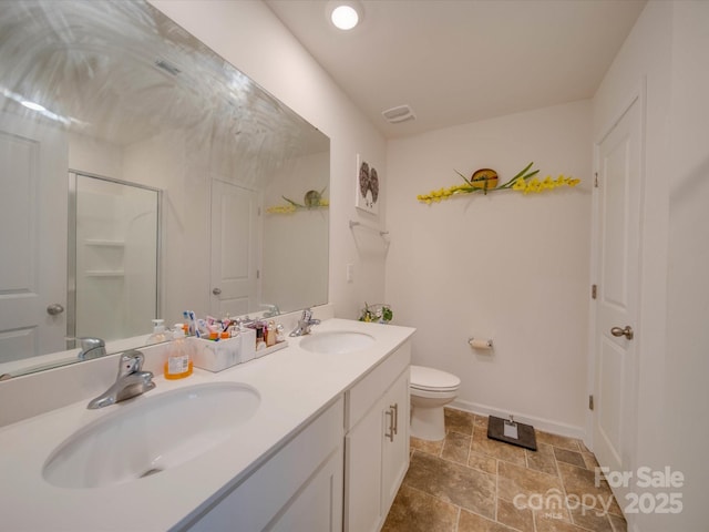 bathroom with vanity, an enclosed shower, and toilet