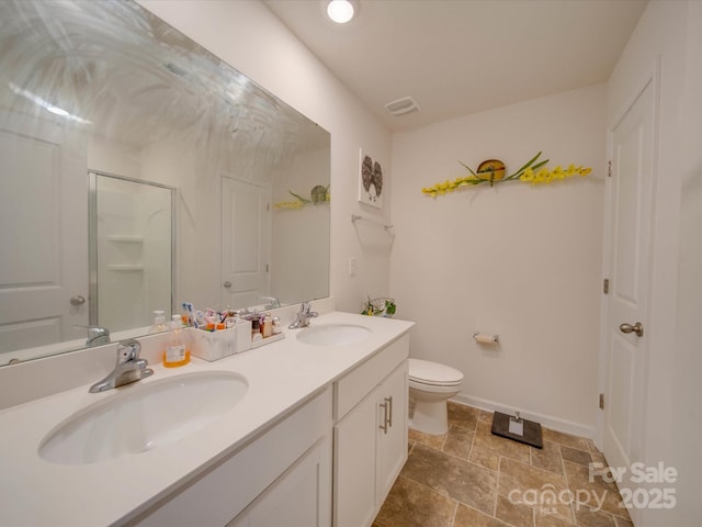 bathroom with walk in shower, vanity, and toilet