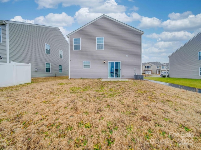 rear view of house featuring a yard