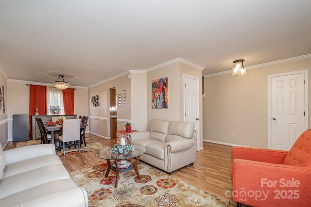 living room featuring ornamental molding and light wood-type flooring