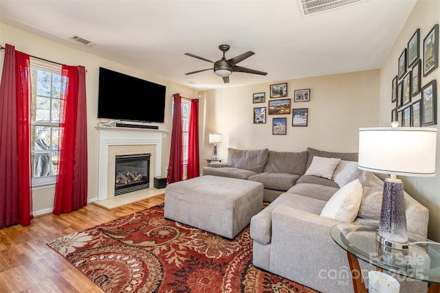 living room featuring wood-type flooring and ceiling fan