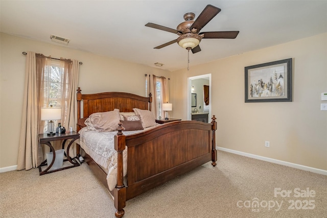 carpeted bedroom with ceiling fan and ensuite bath