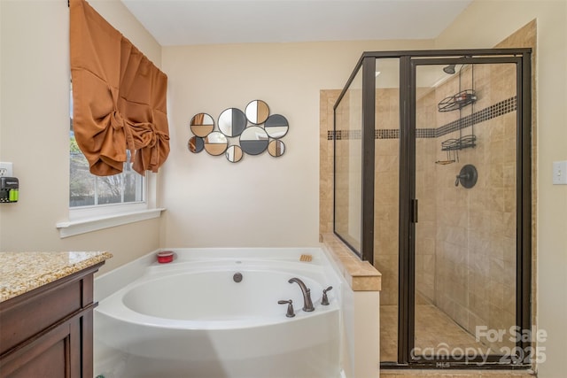 bathroom with vanity and independent shower and bath