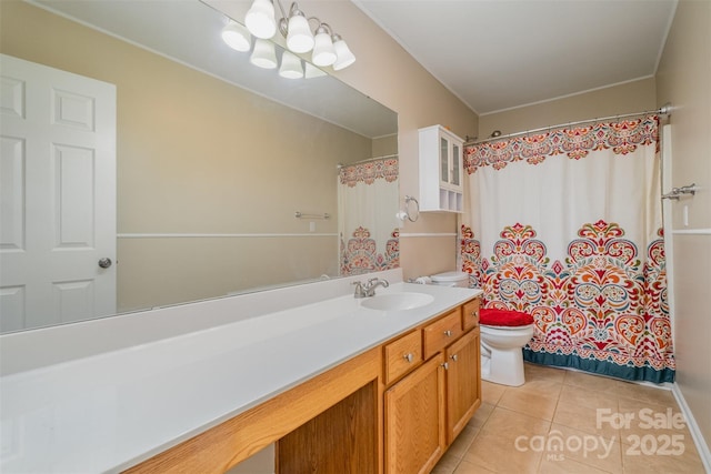 bathroom featuring vanity, tile patterned floors, and toilet