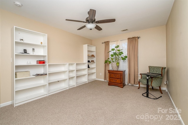 sitting room with carpet floors and ceiling fan