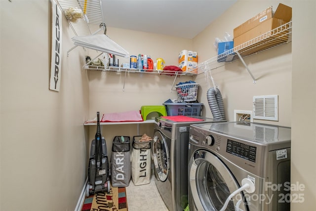 clothes washing area with washing machine and clothes dryer