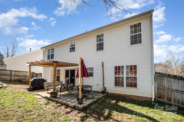 rear view of property featuring a pergola, a yard, and a patio