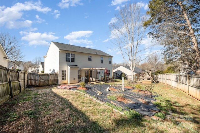 rear view of house featuring a patio, a deck, and a lawn