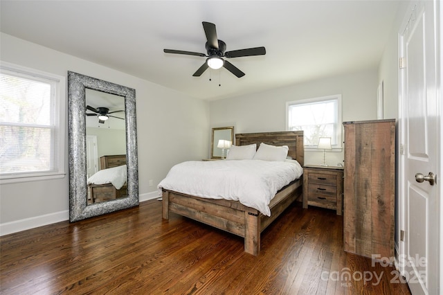 bedroom with dark wood-type flooring, ceiling fan, and multiple windows