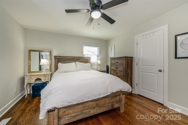 bedroom with dark hardwood / wood-style floors and ceiling fan