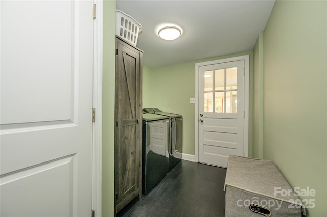 laundry room with dark hardwood / wood-style flooring and washing machine and dryer