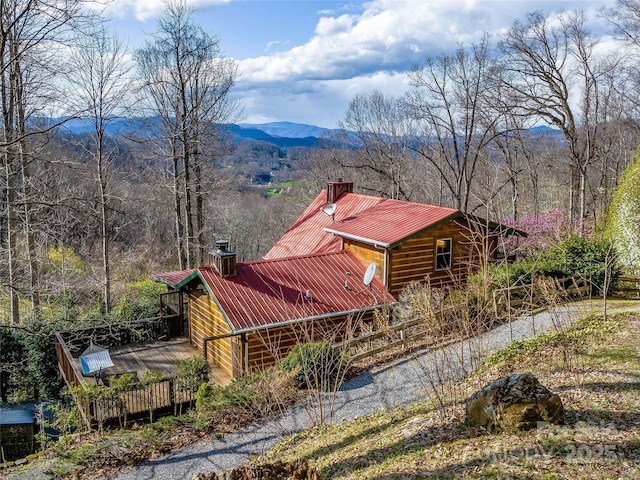 exterior space featuring cooling unit and a deck with mountain view