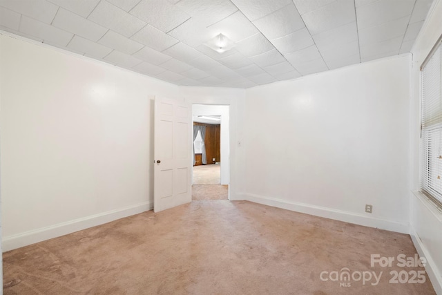 unfurnished room featuring light carpet