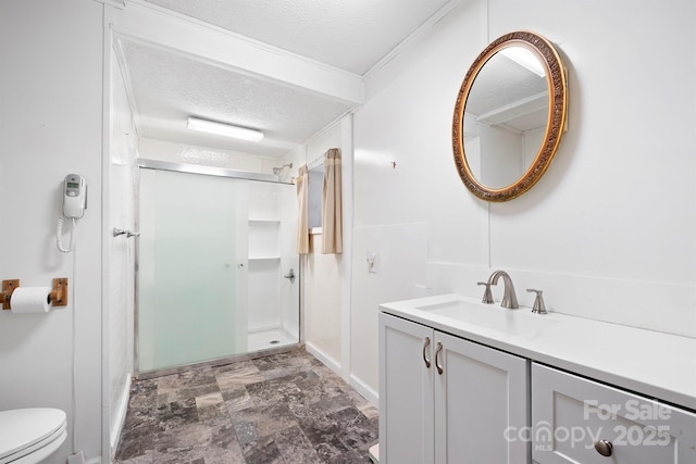 bathroom with vanity, ornamental molding, a textured ceiling, and walk in shower