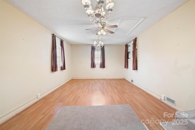 spare room featuring ceiling fan with notable chandelier, a textured ceiling, and light wood-type flooring