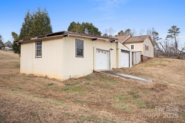 exterior space with a garage and a front lawn