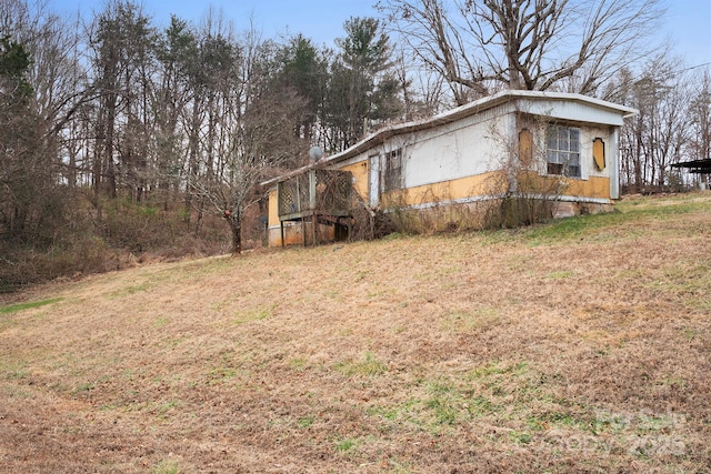 view of side of property with a lawn