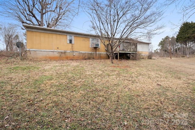 rear view of house featuring a yard and a deck