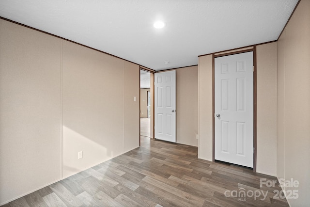 unfurnished bedroom featuring hardwood / wood-style flooring