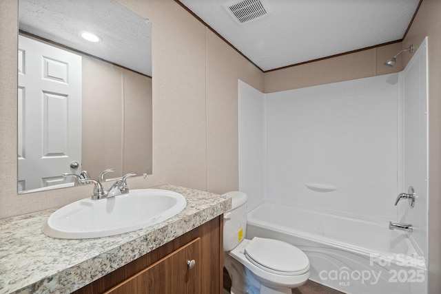 full bathroom with vanity, bathtub / shower combination, a textured ceiling, and toilet