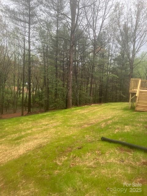 view of yard with stairs and a wooden deck