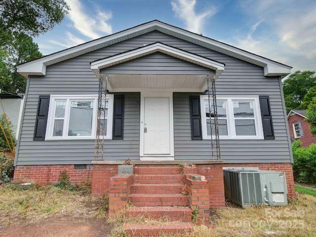 bungalow-style home with cooling unit