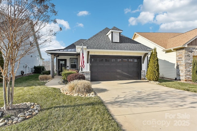 view of front facade with a garage, a front yard, and covered porch