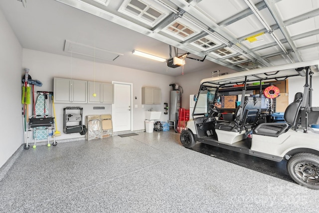 garage featuring water heater and a garage door opener