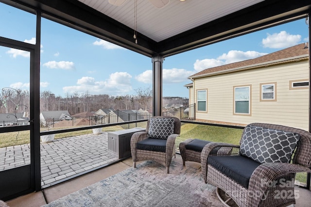 sunroom featuring ceiling fan